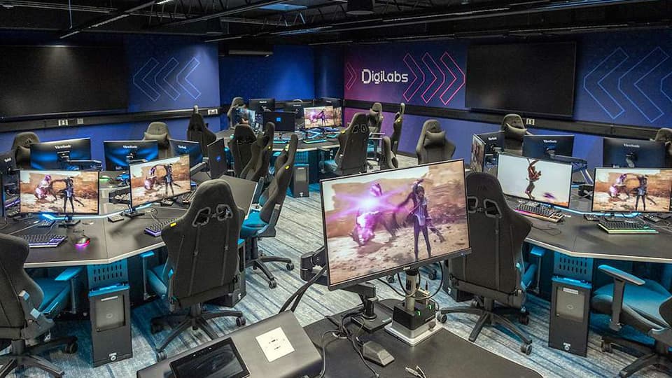 DigiLabs - eSports Lab - a dark-coloured PC lab with hexagonal desk pods and gaming-specific chairs